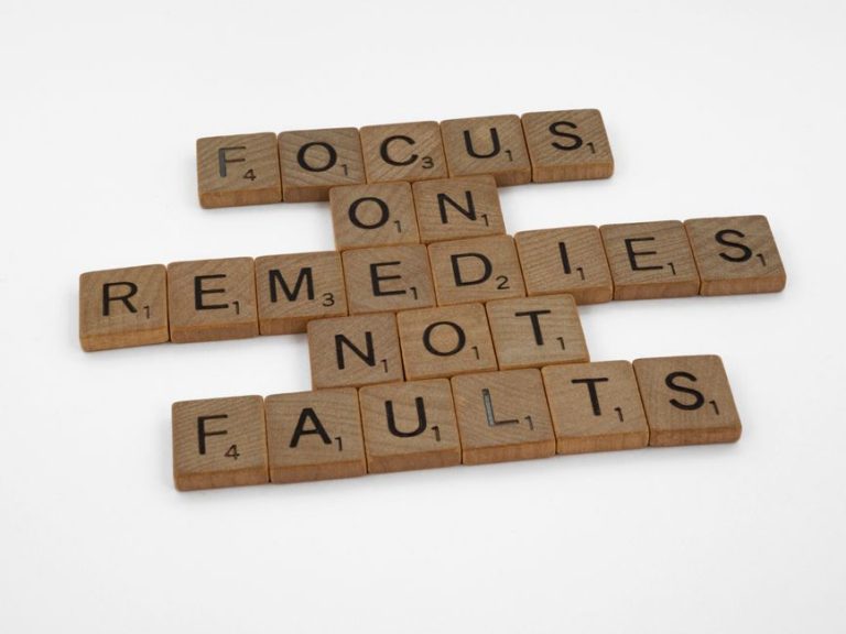 Scrabble tiles spelling an inspirational message on focus and problem-solving.