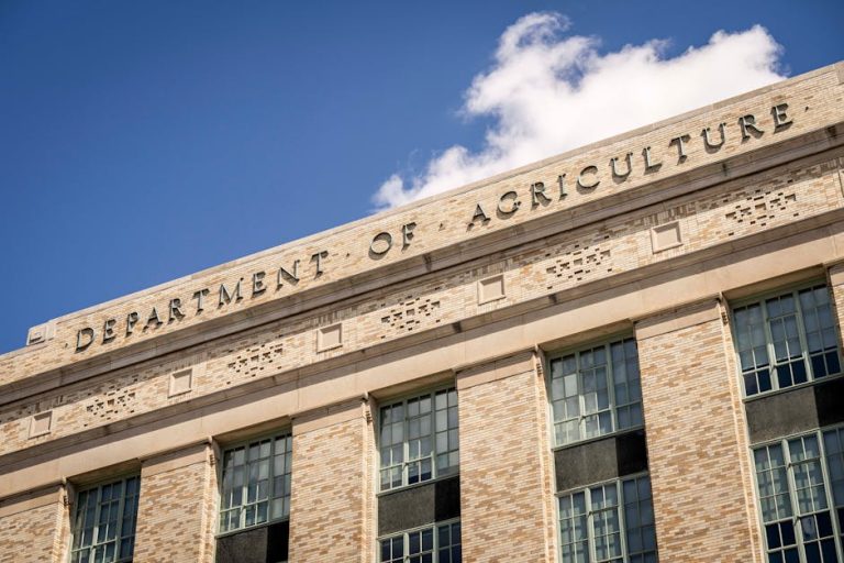 Close-up of the Department of Agriculture building facade under a clear blue sky.