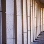 Elegant stone colonnade casting shadows in Feldkirch, Austria.