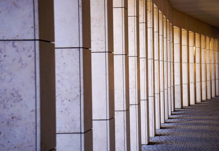 Elegant stone colonnade casting shadows in Feldkirch, Austria.