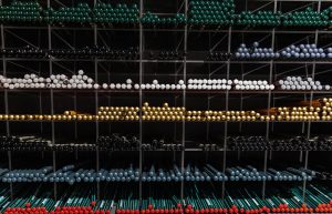 A vibrant assortment of colorful pens organized on shelves for a visually appealing stationery display.