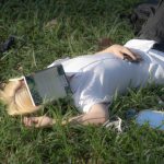 <h1>Federated Causal Inference: The Future of Collaborative Robot Intelligence</h1> Young adult lies on grass in Hanoi park, book covering face, enjoying a sunny day.