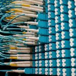 Federated Connectomics: Scaling Distributed Robotics AI Cable organizer with set of various network wires in switch and connected with equipment