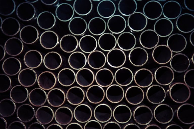 A detailed macro shot of stacked metal tubes forming a circular pattern, highlighting industrial design.