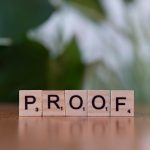 <h1>Few-Shot Zero-Knowledge Proofs: Securing the Future of Advanced Materials</h1> Wooden Scrabble tiles spelling 'PROOF' on a wooden table with green background.