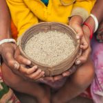Food Security: The Foundation of Futurist Strategy and Operations Close-up of hands holding a woven basket filled with rice in Bangladesh.