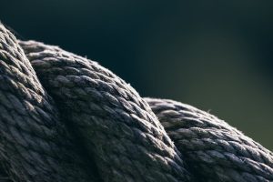 Detailed macro of a helically twisted rope showcasing texture and shadow play.