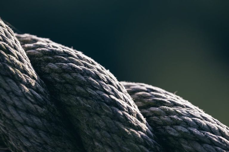 Detailed macro of a helically twisted rope showcasing texture and shadow play.