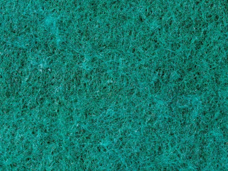 Close-up view of an emerald green textured surface, ideal for background use.