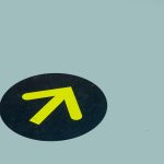 Guide to Symbol-Grounded Topological Computing in Nanotech Minimalist image of a yellow arrow on a blue floor indicating direction, ideal for navigation themes.