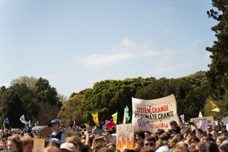 Crowd holding signs at a climate change protest in Sydney, Australia.