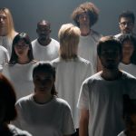 <h1>Human-In-The-Loop Decentralized Identity: The Future of Biotech Data Sovereignty</h1> A diverse group of individuals in white shirts standing in a studio setting.