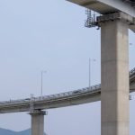 Human-in-the-Loop Nano-Fabrication: Bridging Math and Precision Elegant structure of an elevated concrete highway bridge with a loop design, showcasing modern infrastructure.