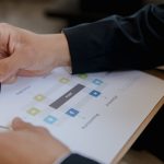 Close-up of a person writing on a business strategy document with a pen.