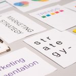 A top view of marketing strategy documents and graphs arranged on a desk, showcasing business planning.