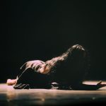 <h1>Interpretable Embodied Intelligence Architecture for Synthetic Media</h1> A woman in a dramatic dance performance, highlighting emotion and movement on stage.