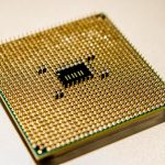 Detailed close-up of a golden microprocessor chip, ideal for technology concepts.