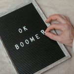 Meme Theory: How Cultural Currency Shapes the Future of Strategy A close-up of a hand arranging letters to spell 'OK Boomer' on a felt letter board.