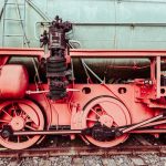 Memetic Engineering: How Cultural Viral Loops Shape Future Markets Detailed close-up of a vintage steam locomotive's wheels and mechanical parts. Industrial and historical charm.
