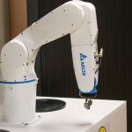 Meta-Learning Cellular Robotics: The Future of Distributed Ledger Close-up of a Delta brand robotic arm in an industrial setting, showcasing automation technology.