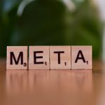 Meta-Learning and DLT for High-Entropy Alloy Discovery Wooden letter blocks spell META on a table with a blurred green background.