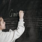 <h1>Meta-Learning Theory of Mind: The Future of AI-Driven Cybersecurity Compilers</h1> A girl writes music notes on a blackboard in a classroom, teaching or learning music theory.