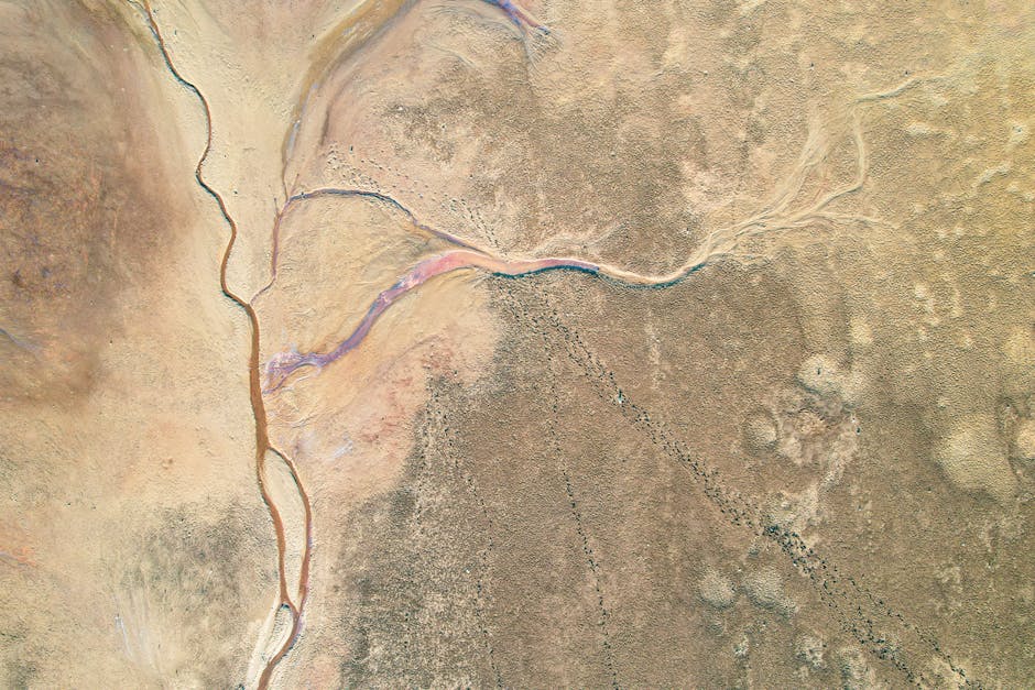 Breathtaking aerial photograph showcasing an arid desert with winding river captured from above.