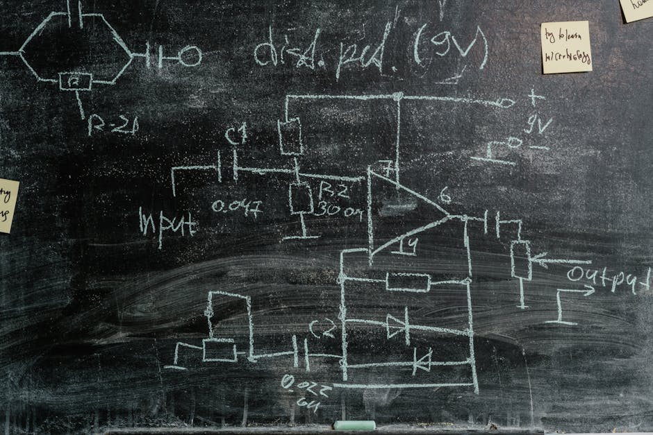 Detailed chalkboard displaying science diagrams and sticky notes, showcasing scientific exploration.