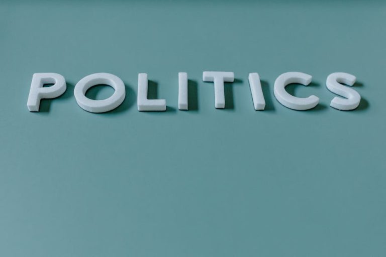 Close-up image of the word 'Politics' against a teal green background, highlighting political themes.