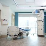 Privacy-Preserving Hospital at Home: Secure HCI Protocols A well-equipped hospital room with a bed and advanced medical equipment.