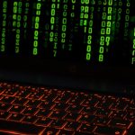 Provably-Safe AI Tutors for Advanced Materials Science Education A laptop keyboard with orange backlight displaying green digital code symbols.