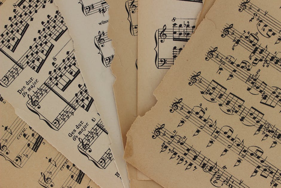 Close-up of vintage sheet music with torn edges, highlighting musical notations and history.