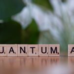 Quantum-Enhanced Machine Learning in Biotechnology Protocols Wooden letter tiles spelling 'Quantum AI' on a blurred background.