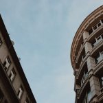 <h1>Real-Time Precision: Building Low-Latency Digital Twins for Bioelectronics</h1> Low angle view of modern city architecture against blue sky, highlighting geometric design.