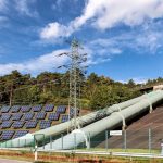Renewable Energy Strategy as a Foundational Public Health Mandate Solar panels and industrial pipes in Geesthacht's EnergiePark on a sunny day.