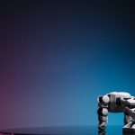 A close-up of a futuristic robot toy on a reflective surface against a gradient background.
