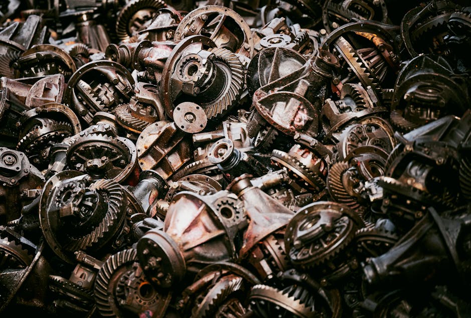 A heap of old mechanical gears in a Bangkok junkyard, showcasing industrial decay.
