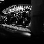 <h1>Risk-Sensitive Neuromorphic Chips: The Future of Resilient Energy Systems</h1> High-stakes gambling at a casino craps table in black and white.