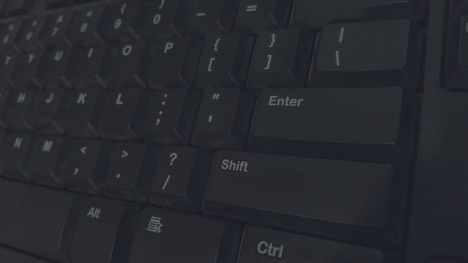 Detailed shot of black computer keyboard showcasing various keys for technology concepts.