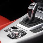 Robust-to-Distribution-Shift Control for Advanced Materials Close-up of BMW Z4 interior showcasing the gear shift and control panel.