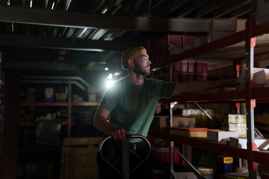 A dedicated worker organizing inventory on warehouse shelves with focused concentration.