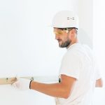 <h1>Safety-Aligned Zero-Knowledge Proofs: Securing the Quantum Frontier</h1> Man wearing safety gear using a spirit level indoors for construction work.