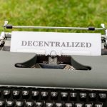 <h1>Scalable Differential Privacy Benchmarking for Edge and IoT Ecosystems</h1> Vintage typewriter outdoors with 'Decentralized' typed paper, symbolizing old meets new in technology.