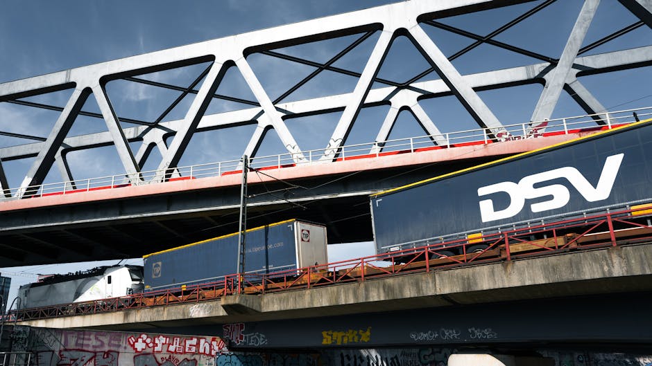 A sleek railway bridge in Hamburg, Germany with freight trains below, showcasing modern infrastructure.