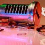 Detailed close-up of metal lock and key parts with colorful reflections, ideal for illustrating technology or security concepts.