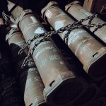 Securing Supply Chains: Implementing Few-Shot DP Compilers Close-up of chained military missile containers in a warehouse.