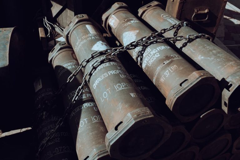 Close-up of chained military missile containers in a warehouse.