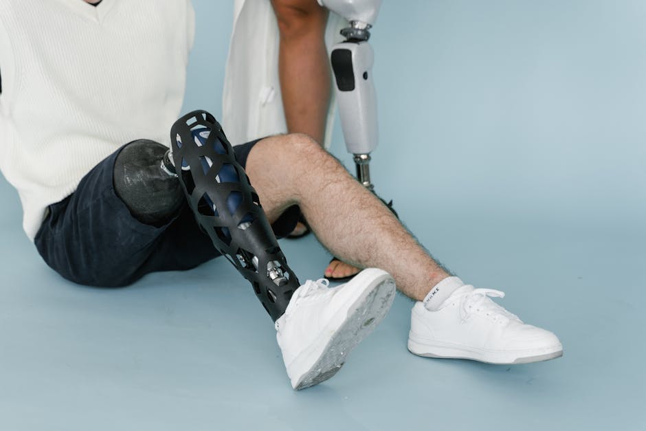 Close-up of a person wearing a bionic prosthetic leg while sitting in a studio setting.