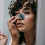 <h1>Self-Healing Carbon Removal Interfaces: The Future of Sustainable Healthcare Infrastructure</h1> Mirror reflection of young female with curly hair putting nose strip mask on face in bathroom