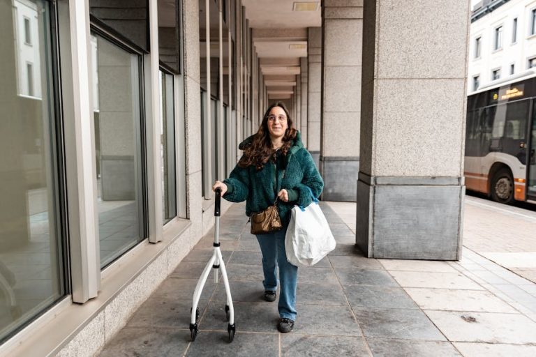 Woman with rollator and shopping bags walking through a modern cityscape